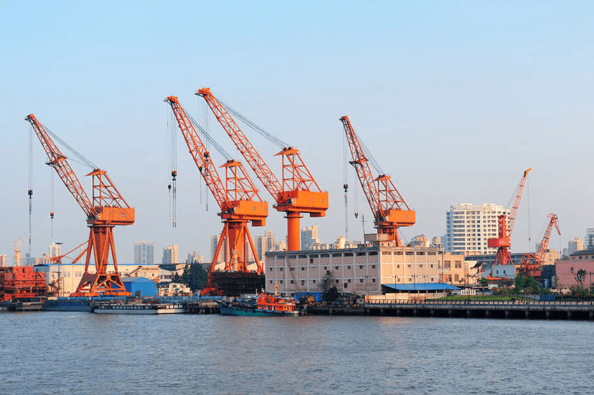 Port cranes handling goods for international trade